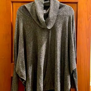 Black with metallic silver thread. Cowl neck tight sleeve.